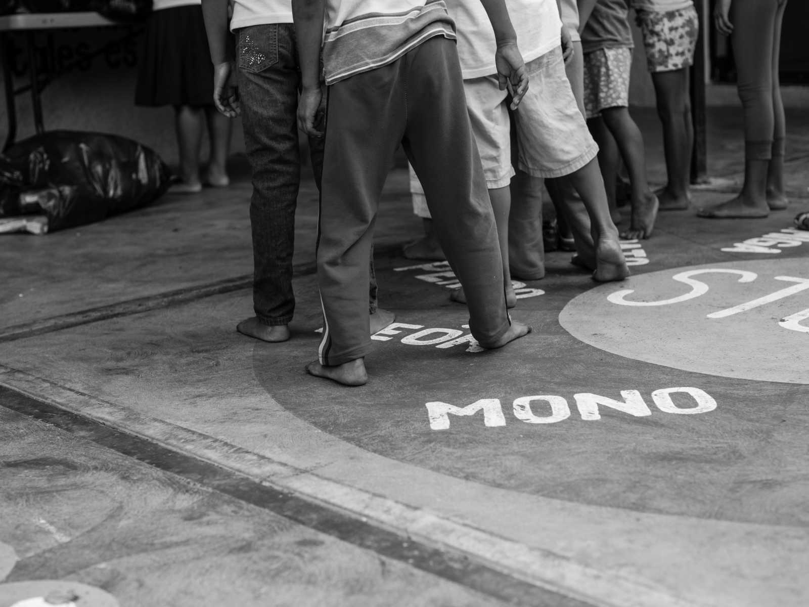 Waist down of children in line at orphanage in Mexico