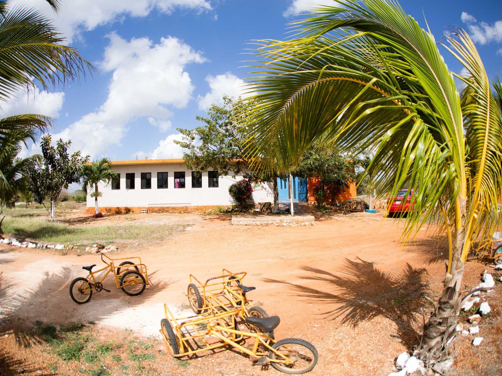 White orphanage in Mexico with yellow bikes in front