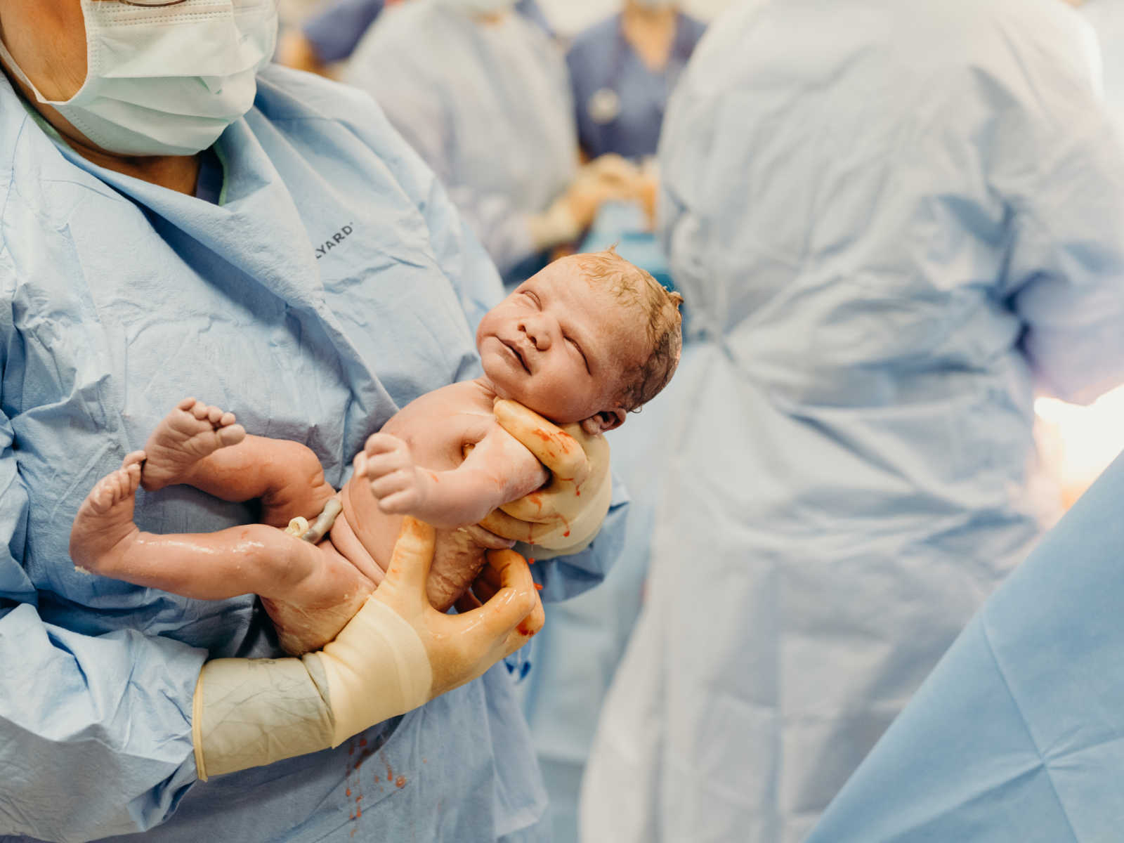Nurse holding newborn baby who won't make it