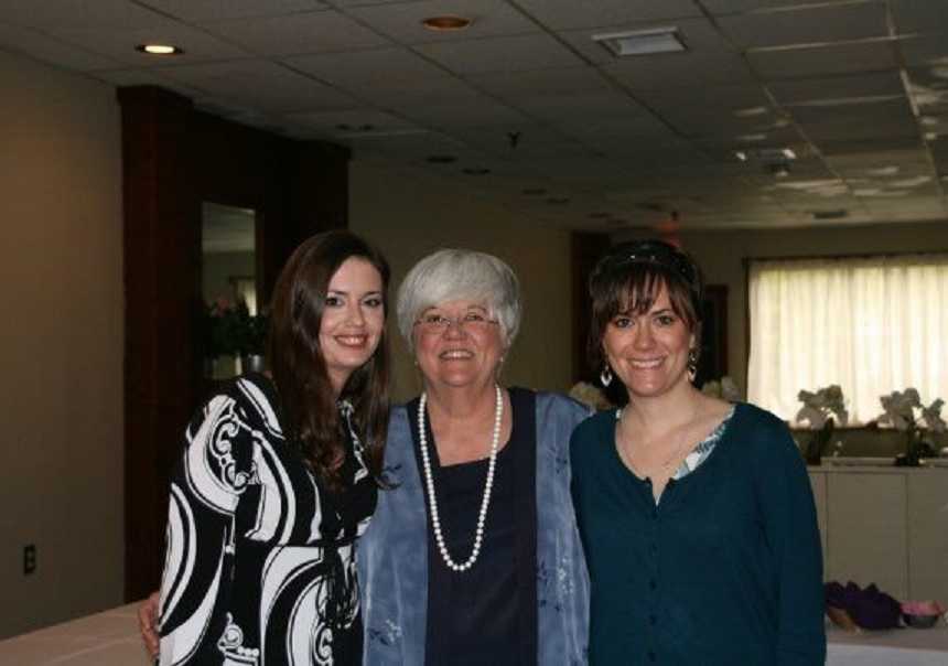 Woman with small cell lung cancer smiles with daughter and granddaughter