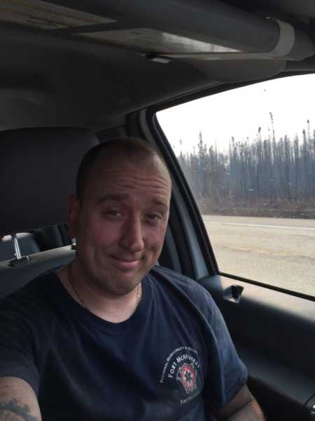 Firefighter father and husband smiles in selfie in his car