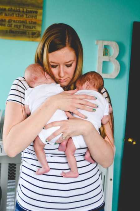 Mother who struggled with fertility hold twins in her arms at home