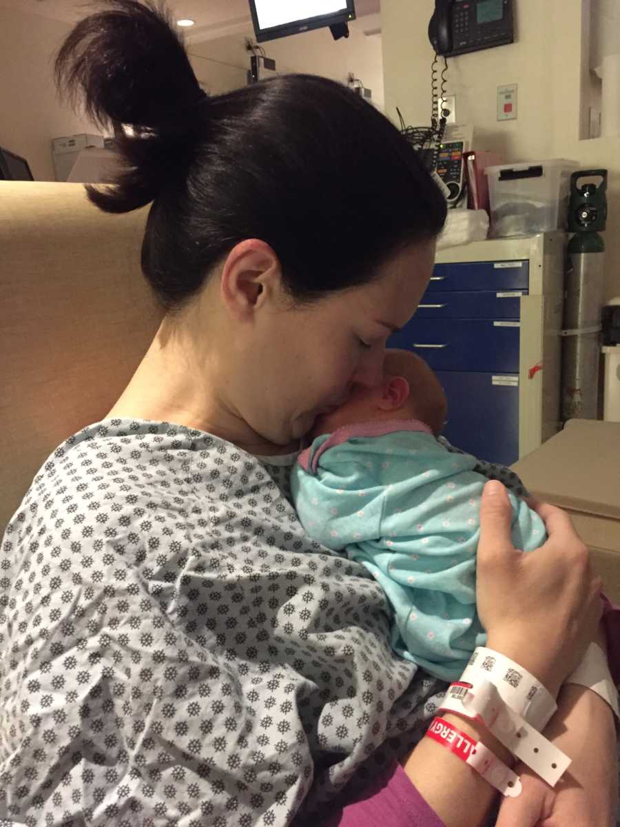 Mother who suffered from ruptured appendix kisses newborn on cheek in hospital