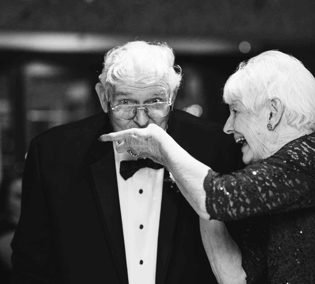 77 year old bride feeds groom at wedding reception