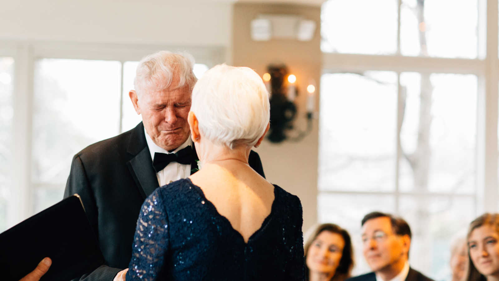 83 year old groom cries at altar while holding 77 year old bride hands