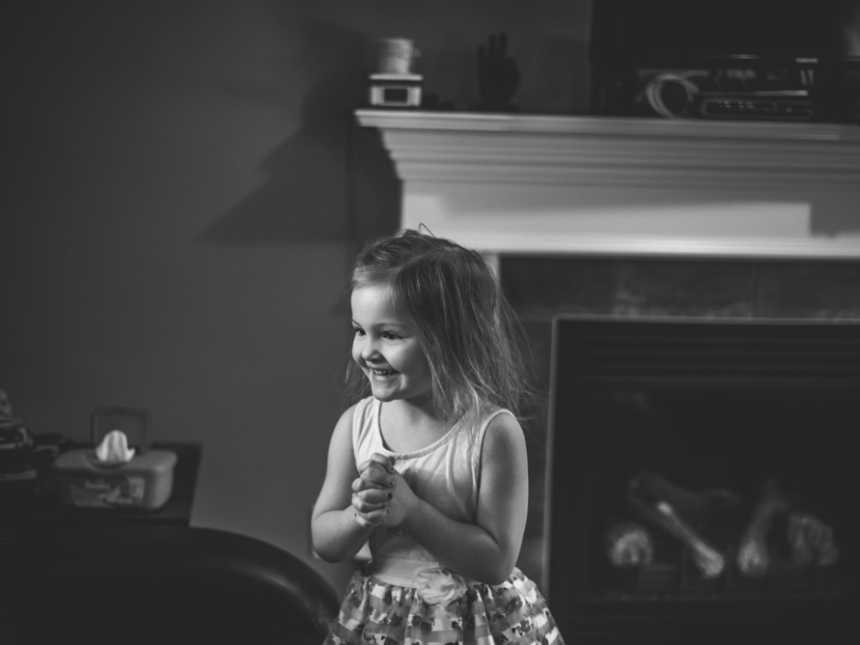 First born smiles while looking at new baby brother 