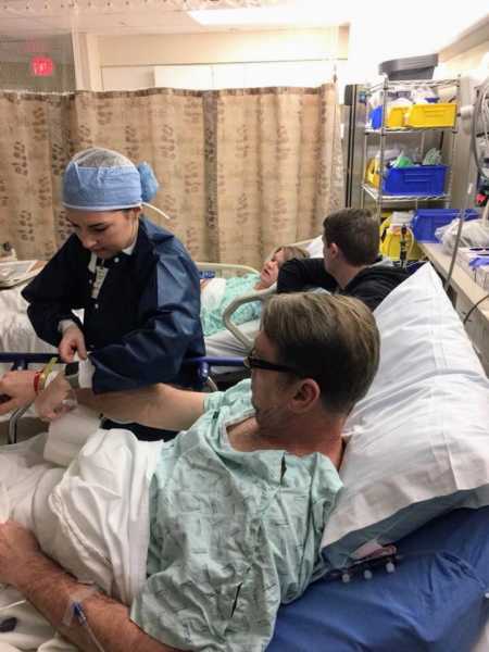 Father and daughter in hospital room before daughter's kidney is removed for father's transplant