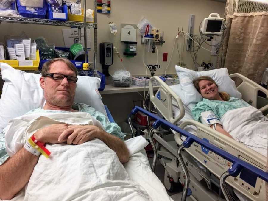 Daughter and father smile in hospital beds as daughter gives kidney to father