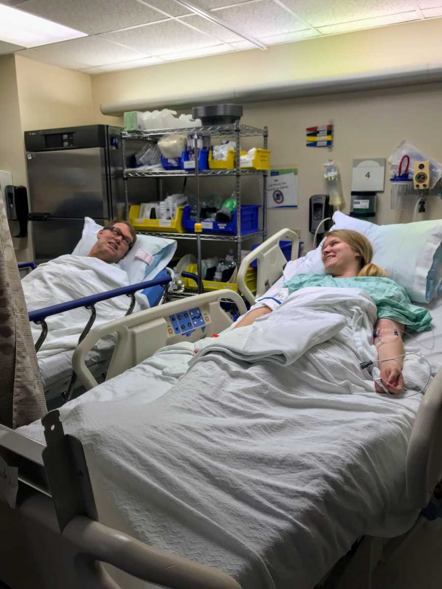 Daughter who gives kidney to her father look at each other in hospital beds