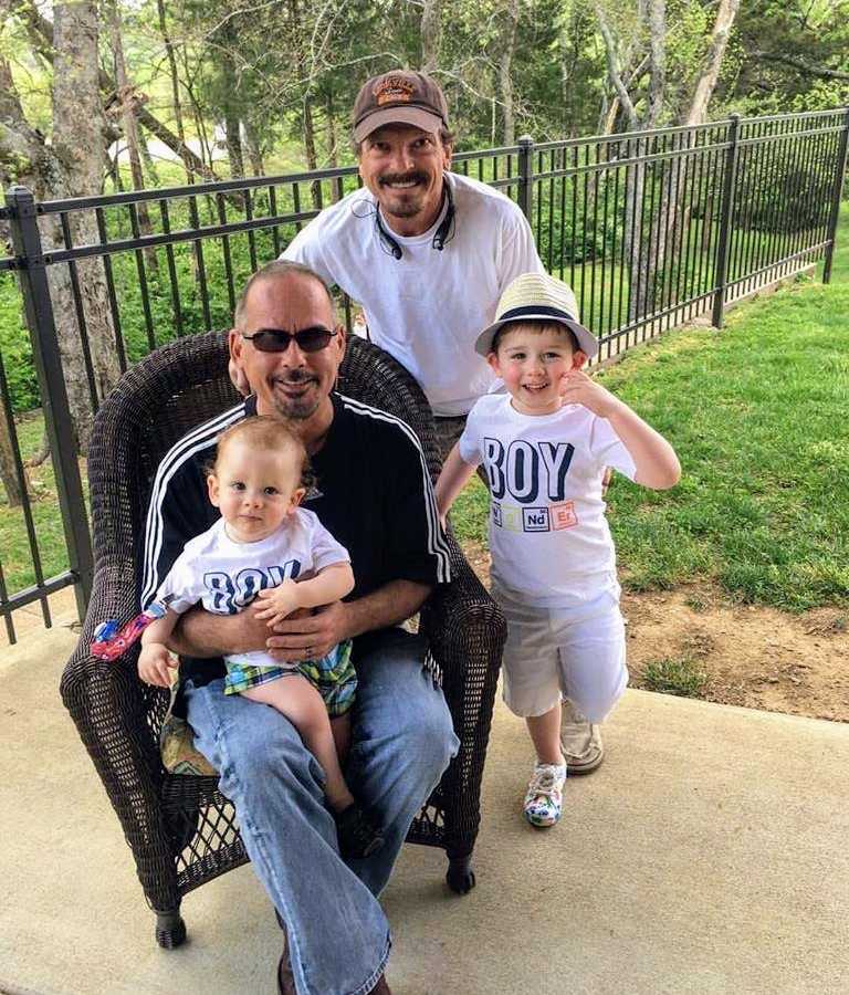 Man who came out as gay in life to his family sits with new husband and two adopted sons