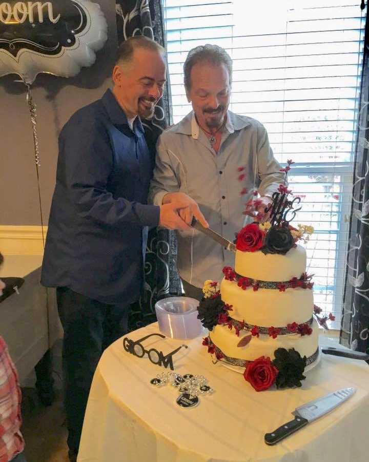 Father who came out to his daughter late in life cuts wedding cake with husband
