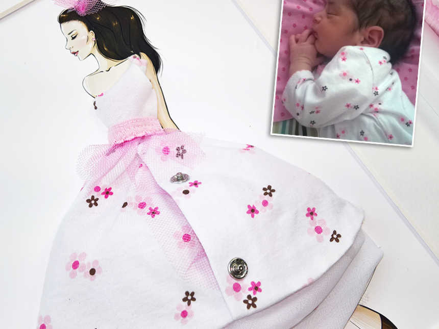 Mother makes paper doll clothing from daughter's baby clothes
