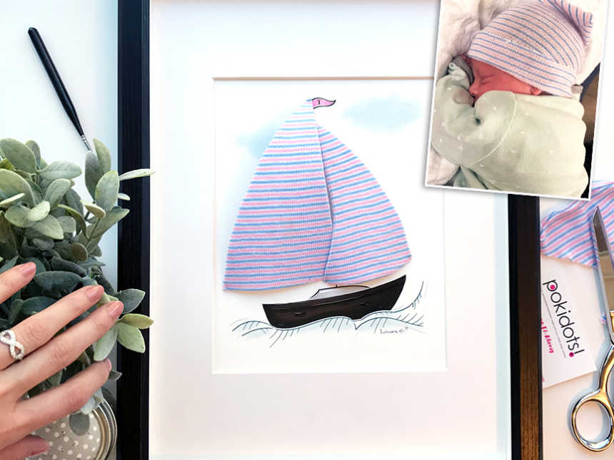 Picture frame of sail boat and sail is made from baby's hat