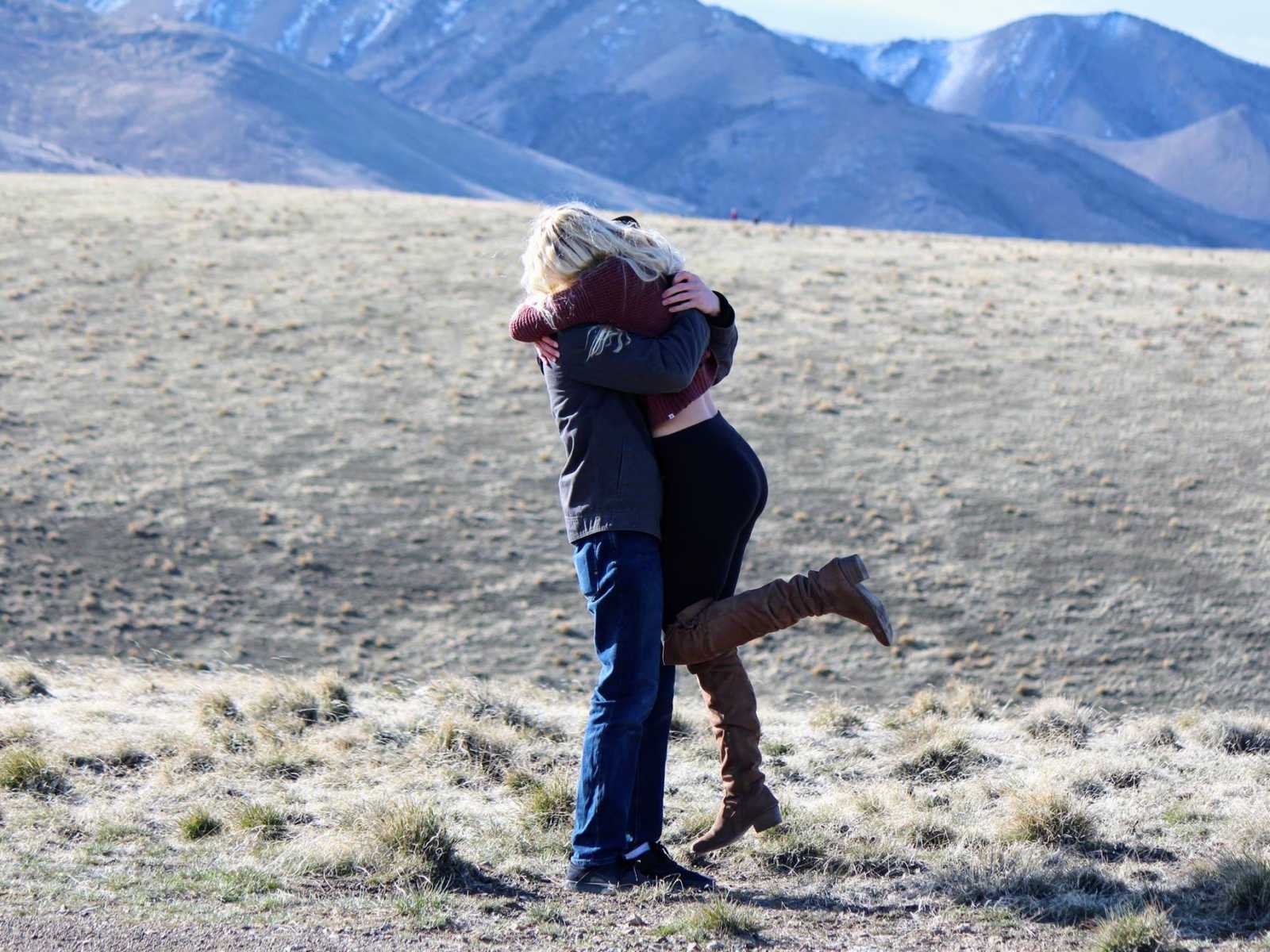 Man hugs and holds fiancee in air after proposal 