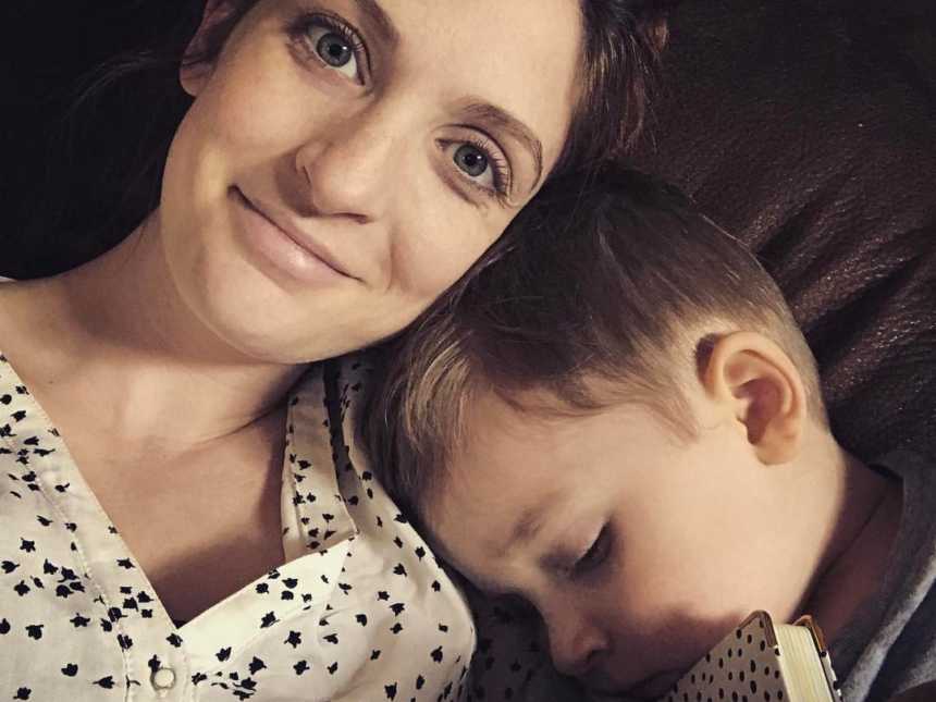 Woman who suffers from mirror-touch synesthesia condition smiles in selfie with son sleeping on her shoulder