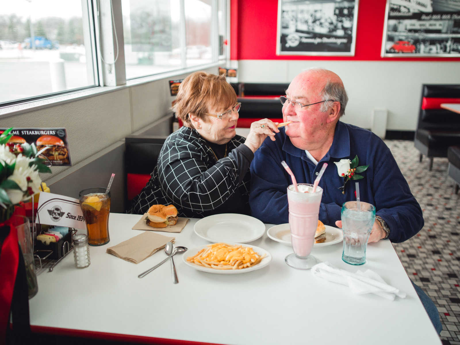 Wife feeds husband a fry in Steak 'n Shake where they met in 1962