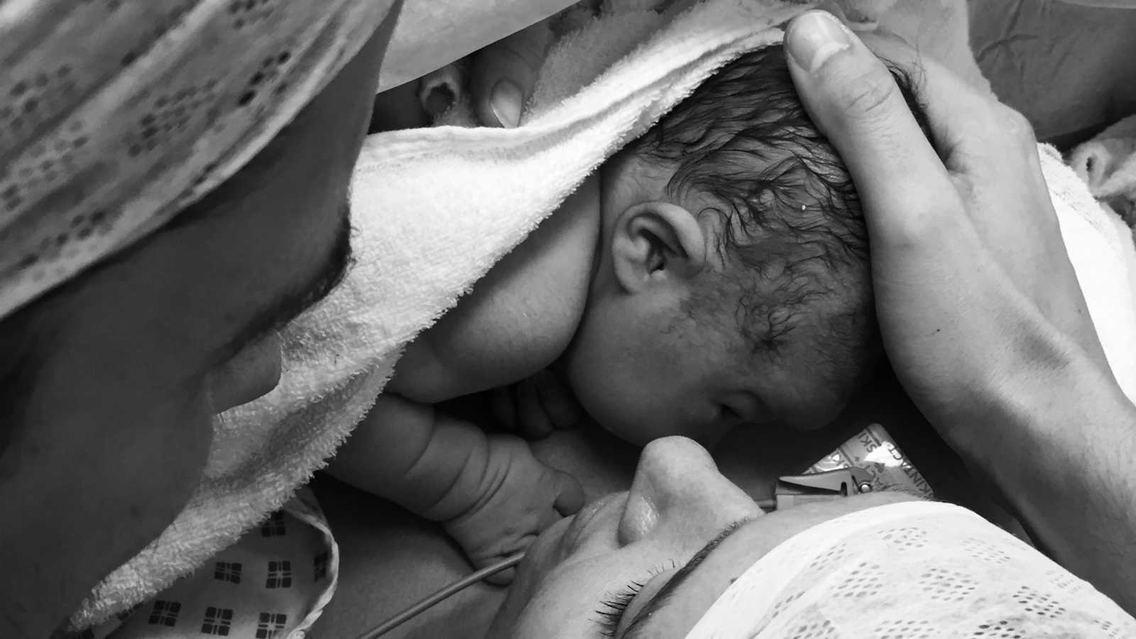 Woman who just had c-section holds newborn to her chest