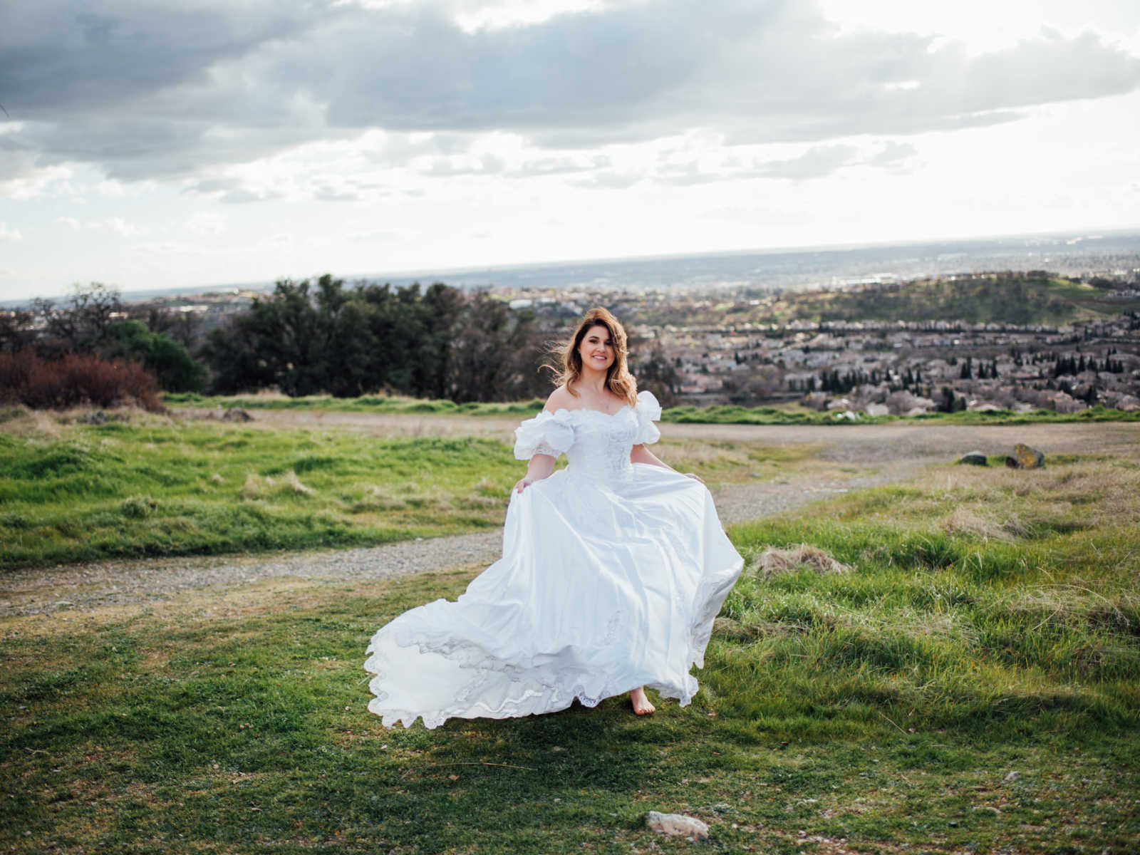 Bride stands in field wearing deceased mother's wedding gown