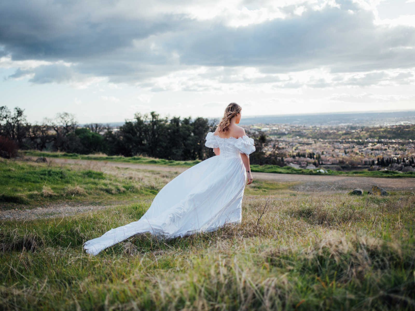 View from the back of bride wearing mother who passed from cancer wedding dress