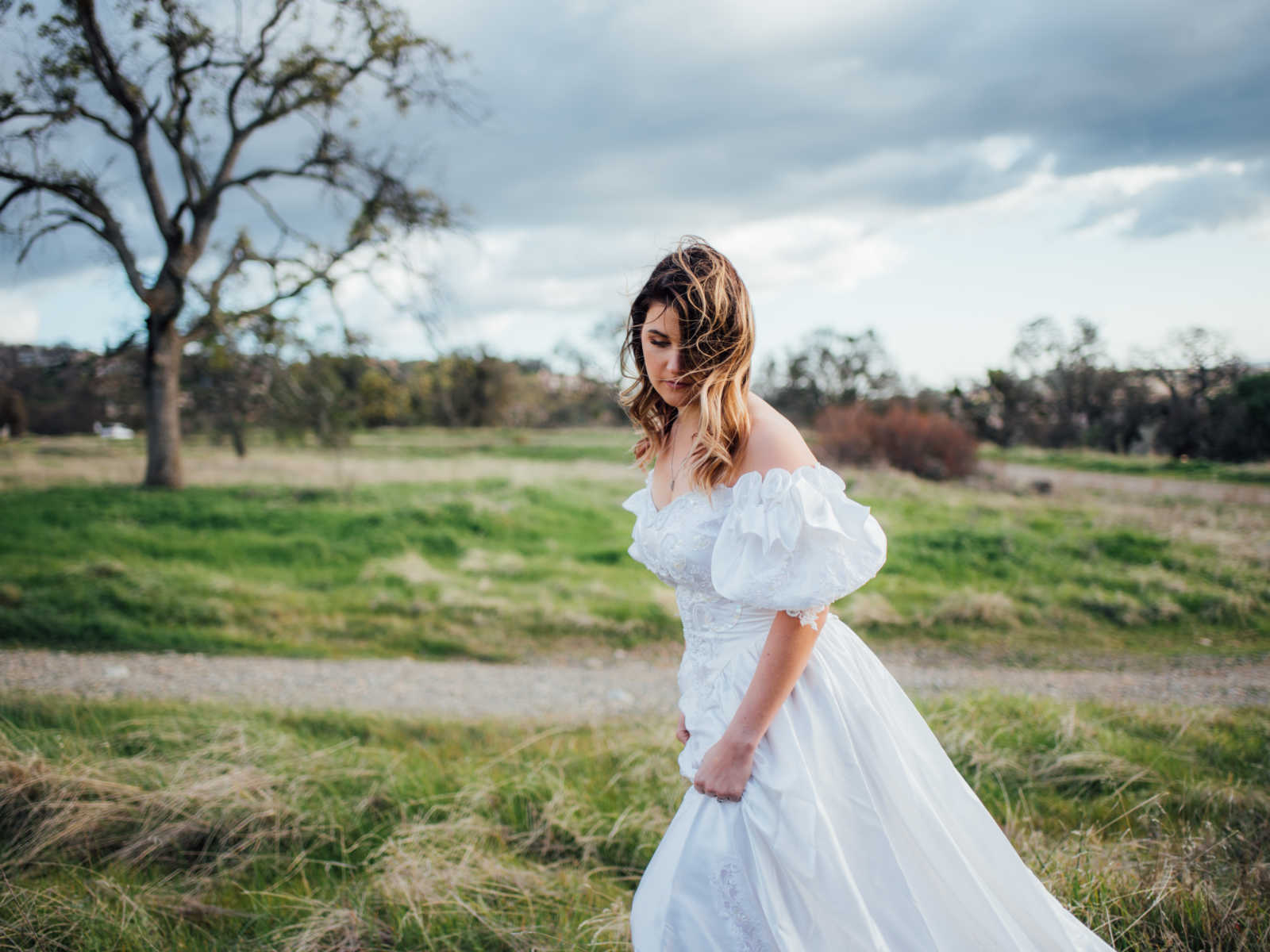 Daughter wears deceased mother's wedding gown with wind blown hair