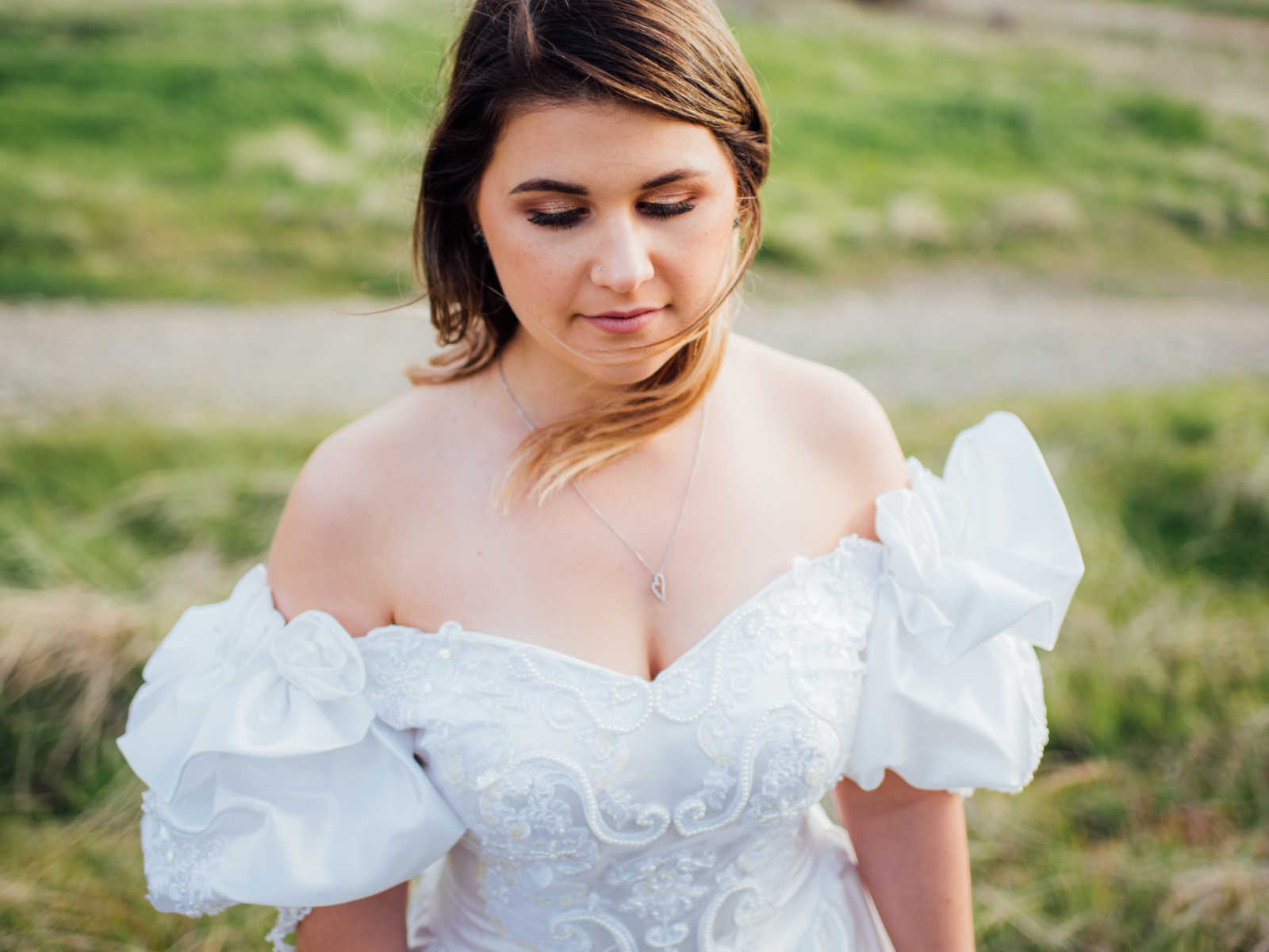Close up of daughter wearing mother who passed from cancers wedding dress
