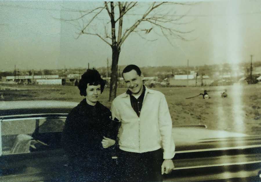 Couple who met at Steak 'n Shake in 1962 smile arm in arm in front of car