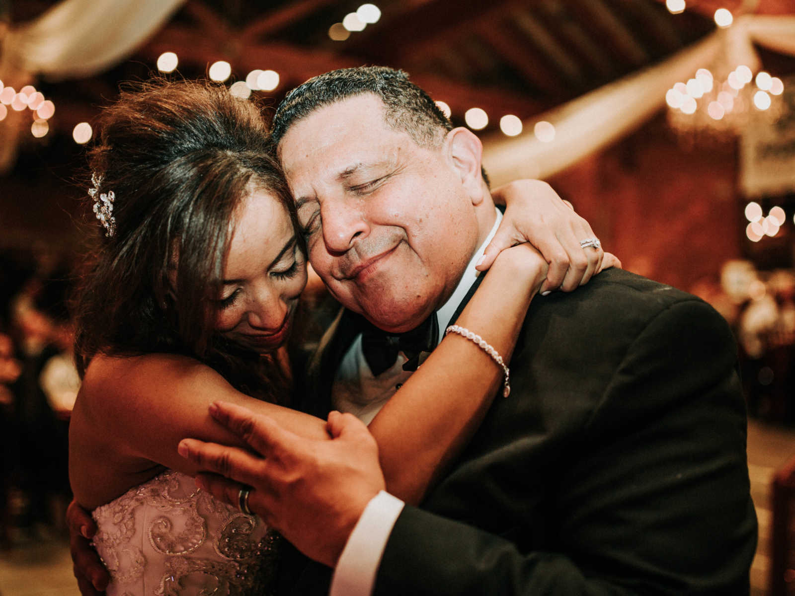 Daughter and father hug at daughter's wedding