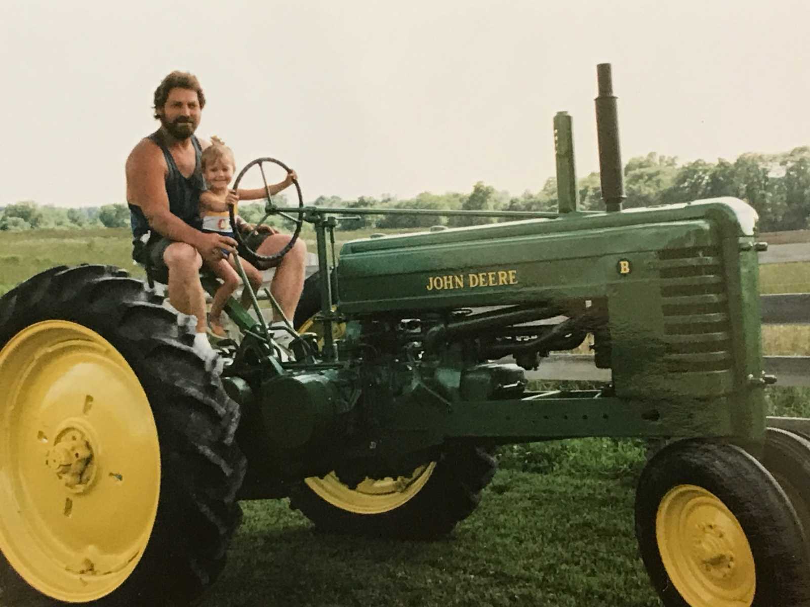 Daughter who pays tribute to farmer dad at wedding sits on John Deere with him when she was little