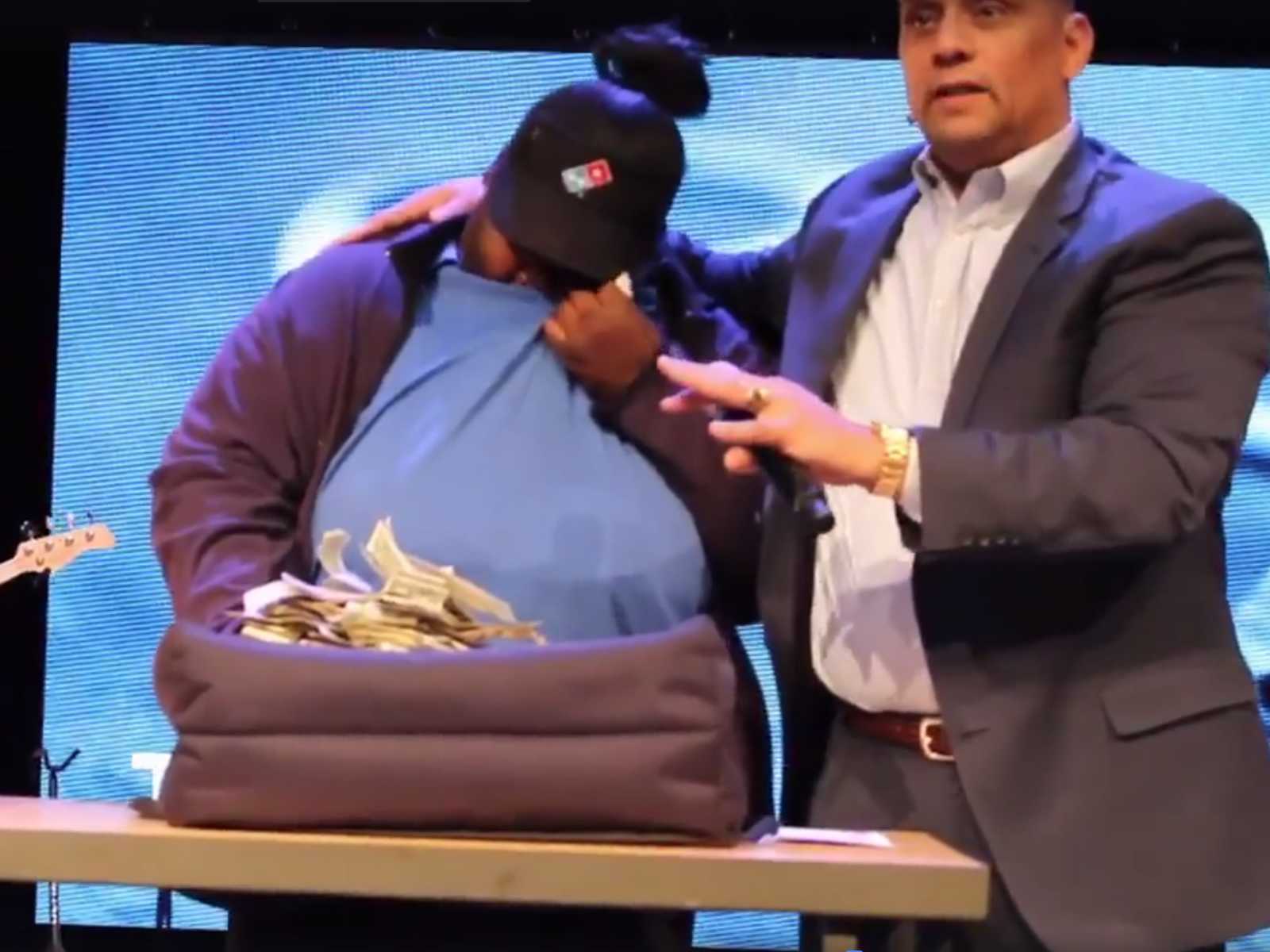 Single mother wipes tears with shirt after receiving large tip for delivering pizza next to pastor of church