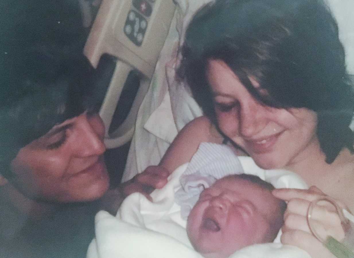 Mother and father looking at newborn baby the day it was born