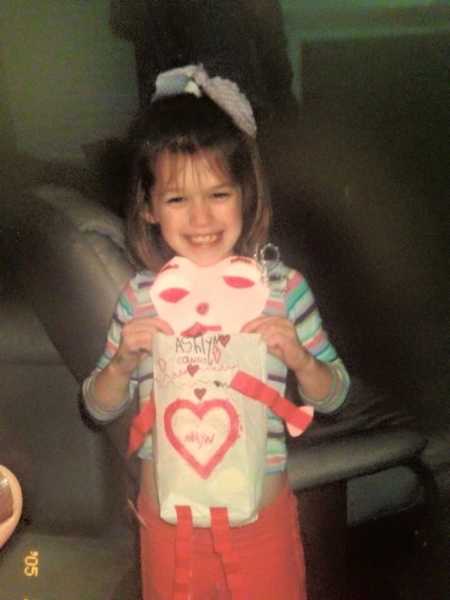 Teen who overdosed on heroin as a little girl holding Valentines Day paper bag