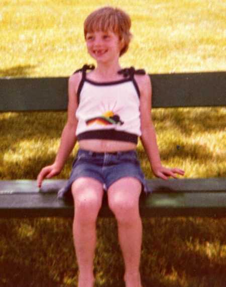 Child sitting on wooden bench and would find ring on farm that would be worn by three generations