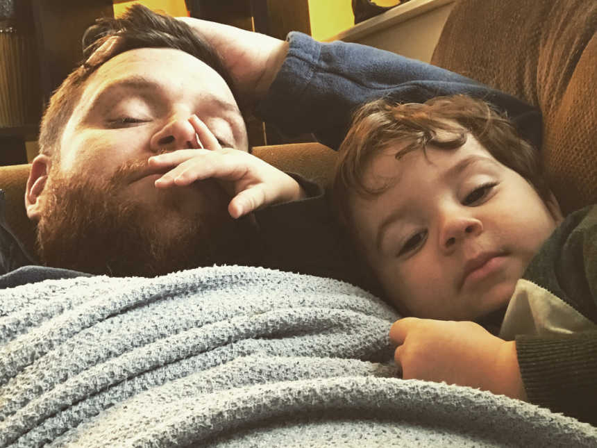 Man who needs kidney transplant in selfie with son while they lie on the couch