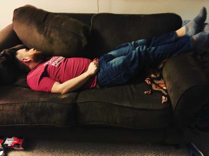 Man who needs kidney transplant asleep on brown suede coach