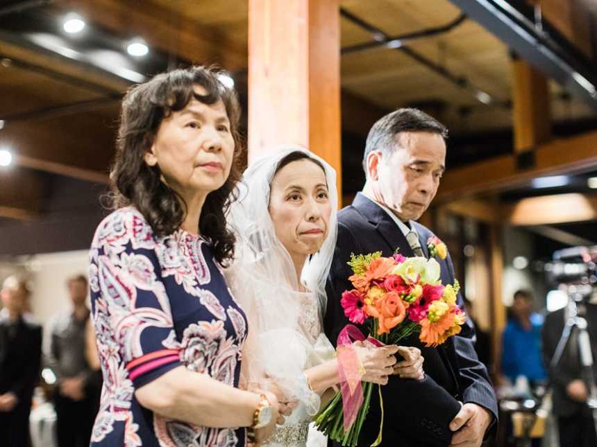 Terminally ill bride stands with her mother and father on either side of her