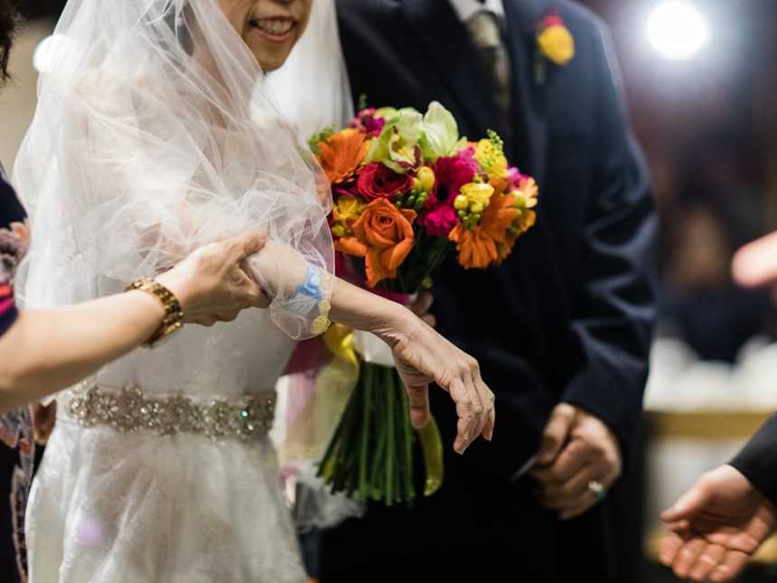 Mother holds terminally ill bride as the walks