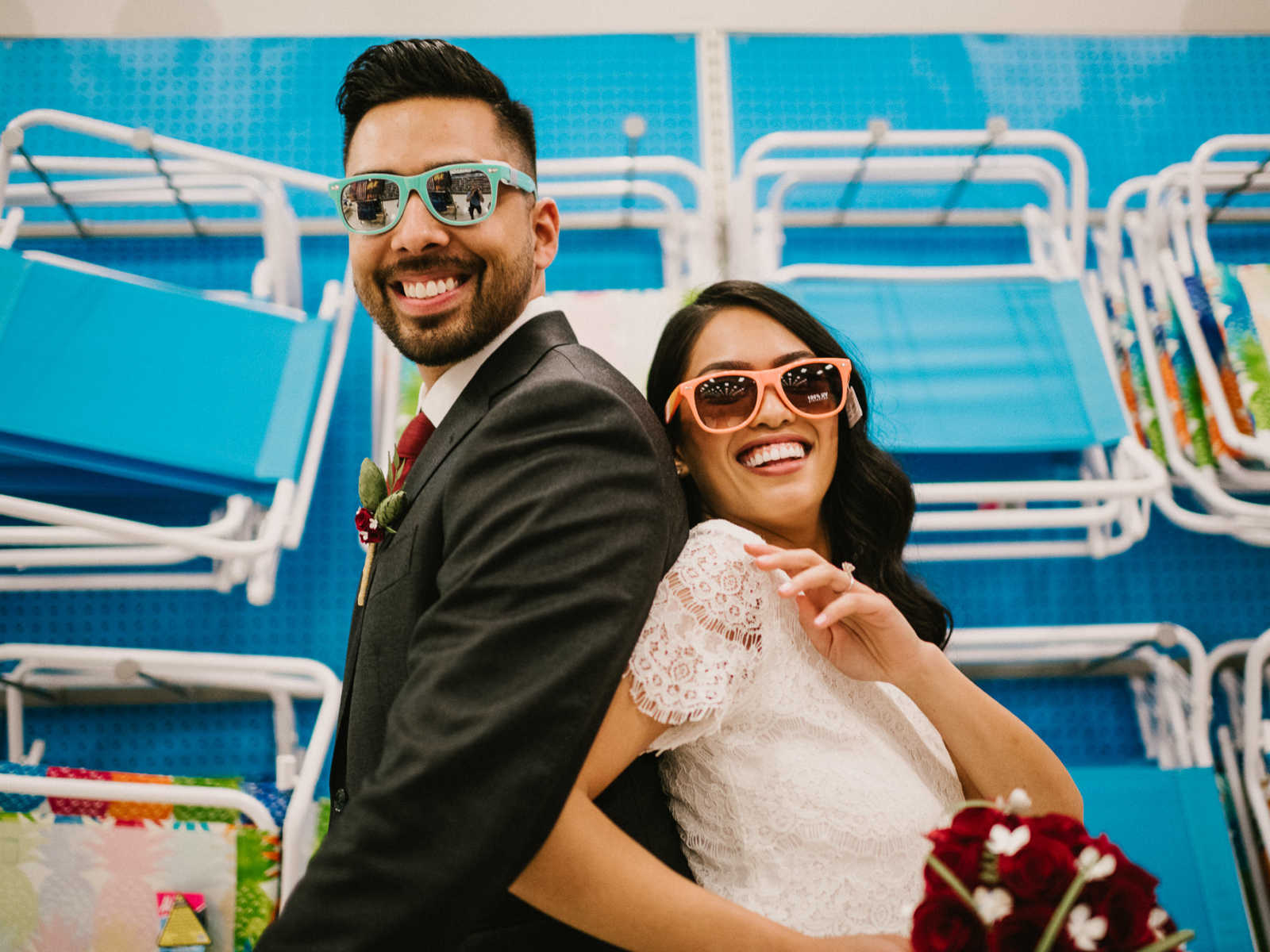Bride and groom smile with sunglasses on in beach chair aisle of Target