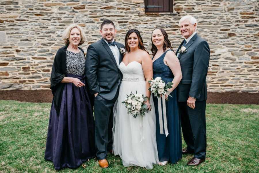 Adopted daughter on her wedding day with husband parents and sister