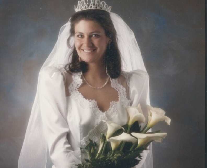 Woman in wedding gown that her aunt sewed for her