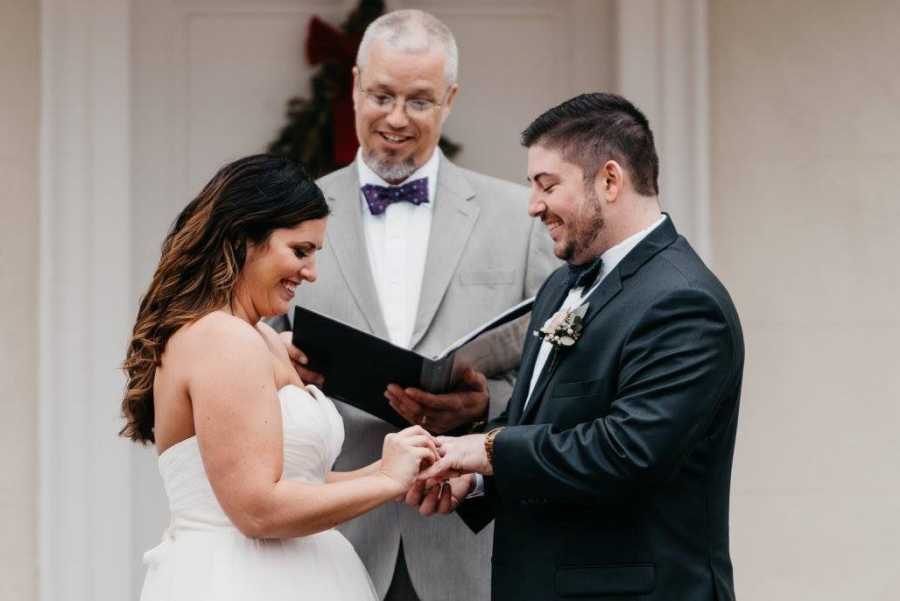 Adopted daughter standing at altar hand in hand with groom 