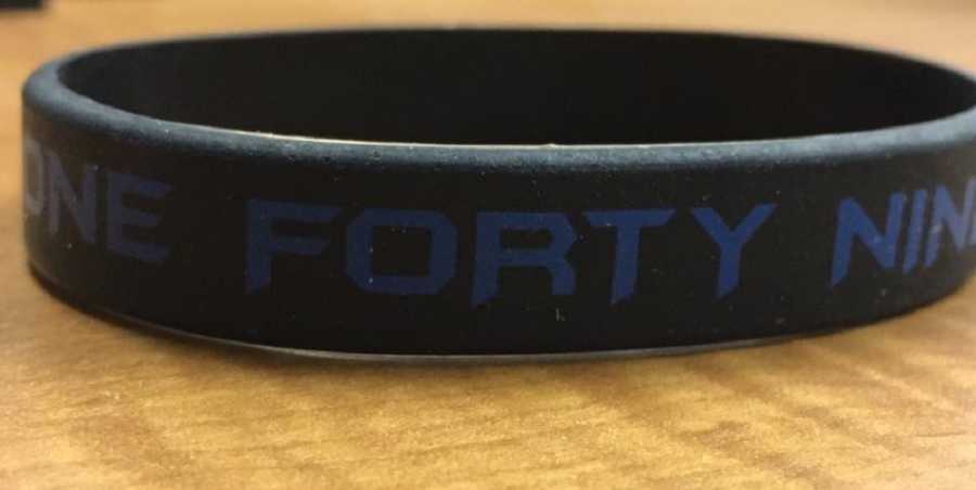 Rubber bracelet with words, "one forty nine" which was deceased cop's badge number