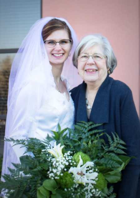 Bride smiling with mother wearing wedding dress her grandmother made