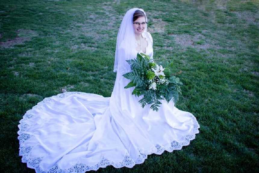 Bride standing in wedding gown that was made by her grandmother