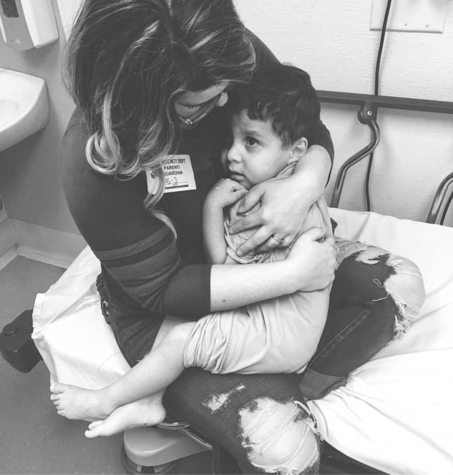 Woman holds adopted son in her lap at hospital 