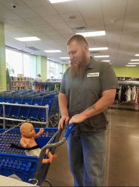 Man pushing daughter's baby doll in shopping cart