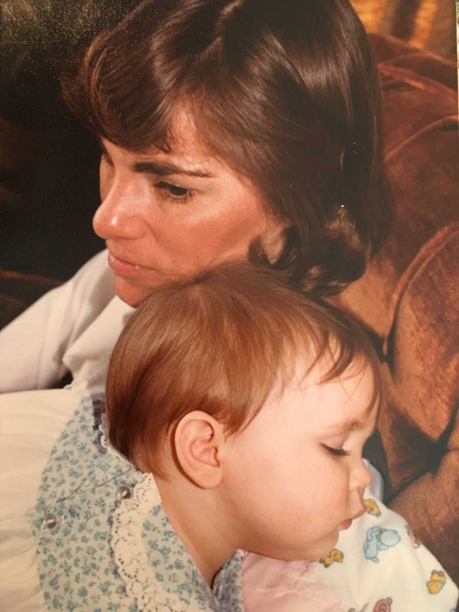 Close up adopted daughter sleeping on mother's shoulder when she was a baby