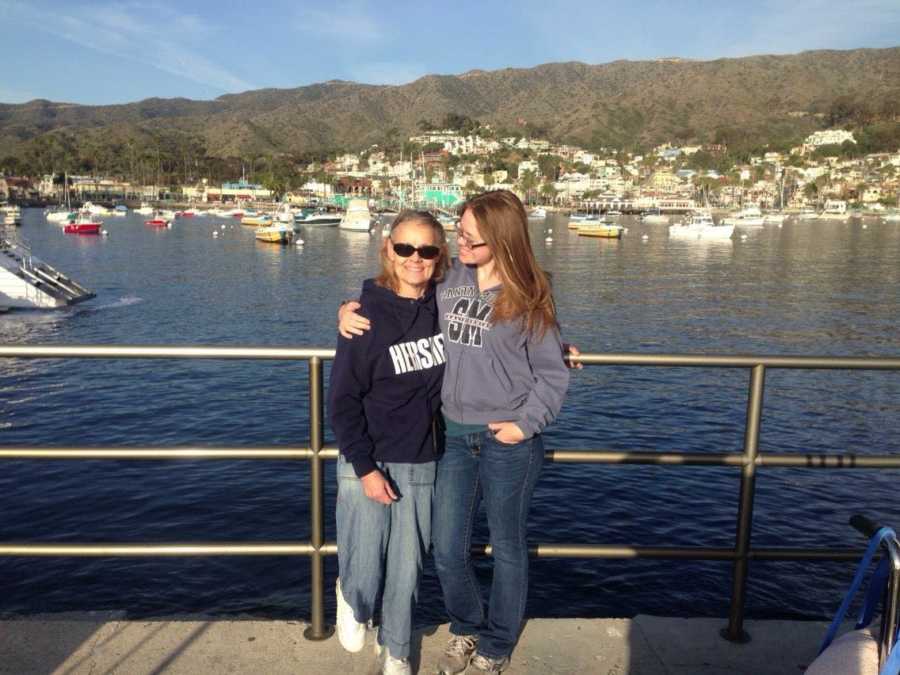 Daughter has arm around mother who gave her medication for her ADHD on pier