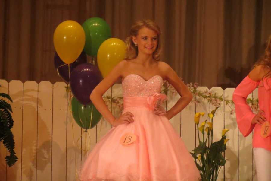 Teen with epilepsy smiling in pink gown at pageant 