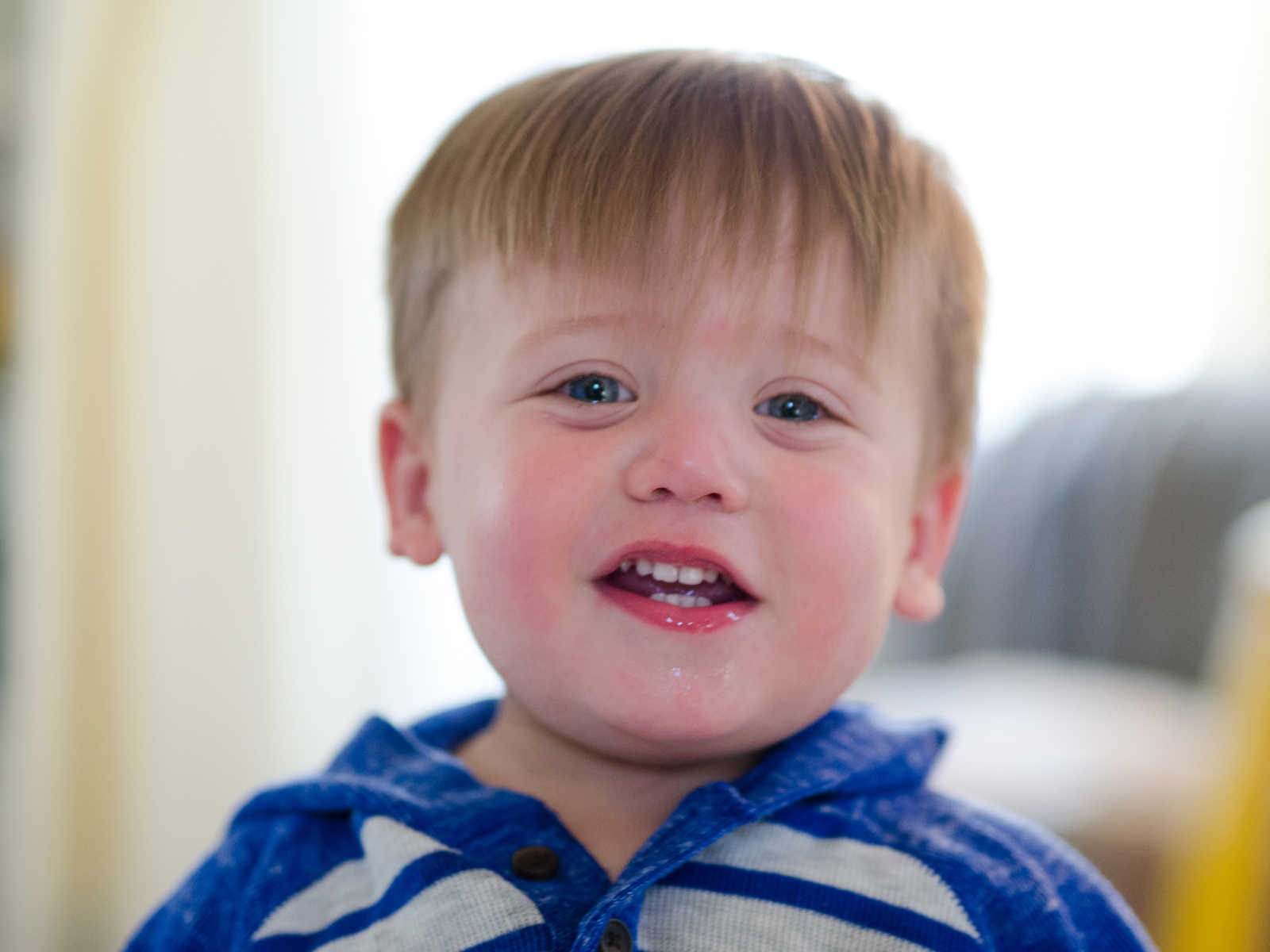 Toddler boy who was adopted smiling