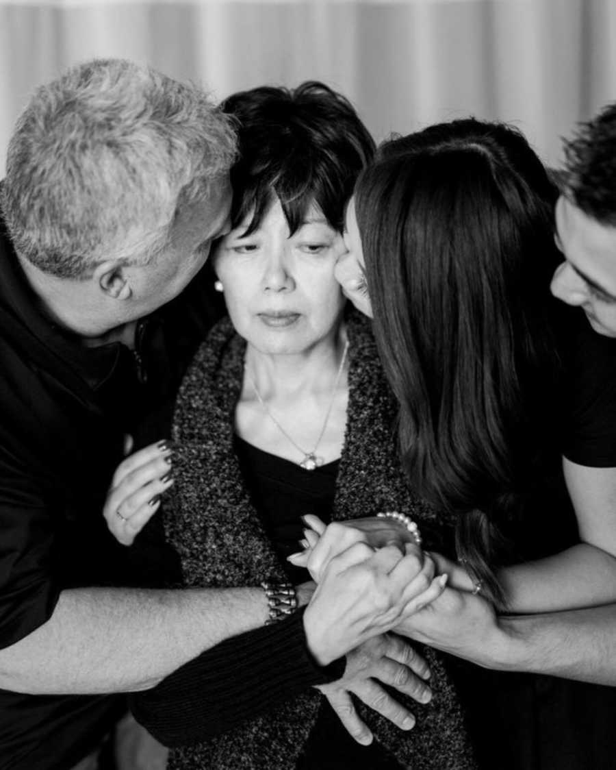 Terminally ill woman receives kiss on each cheek from husband and daughter